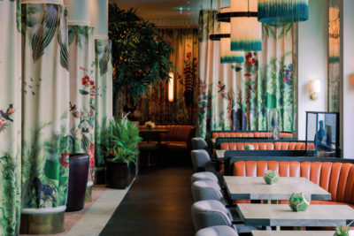 Botanical themed restaurant with floral patterned curtains