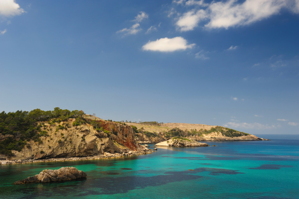 Cala Xarraca, Ibiza Spain turquoise sea and cliffs Fincadelica, Ibiza