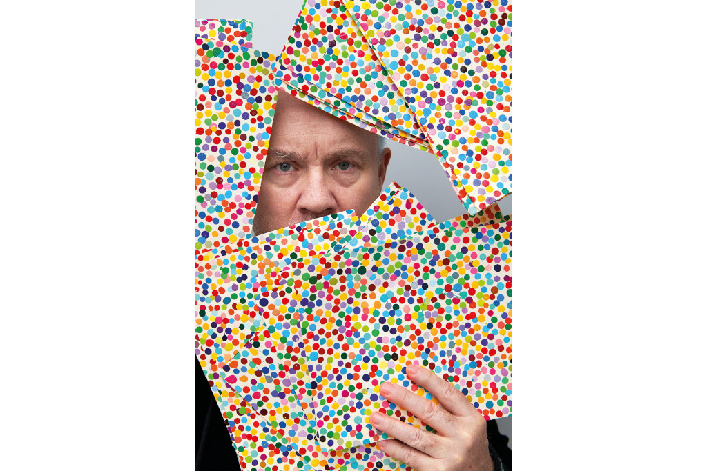 Damien Hirst with some of the 10,000 pieces in The Currency, which can be bought as physical works or NFTs