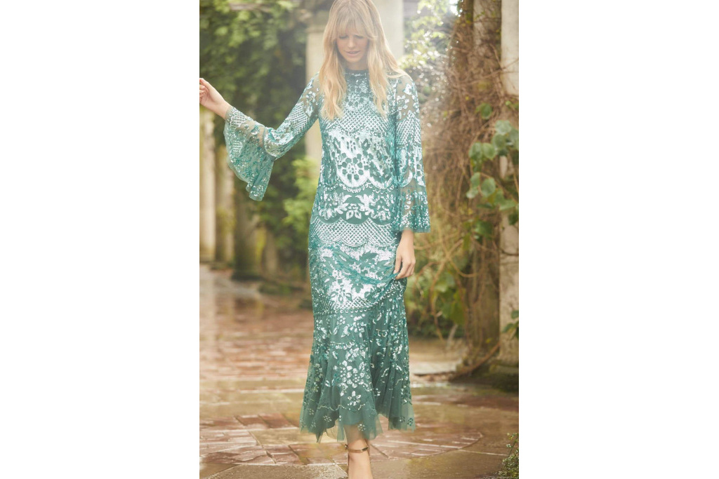 Model in green sequin gown with long sleeves
