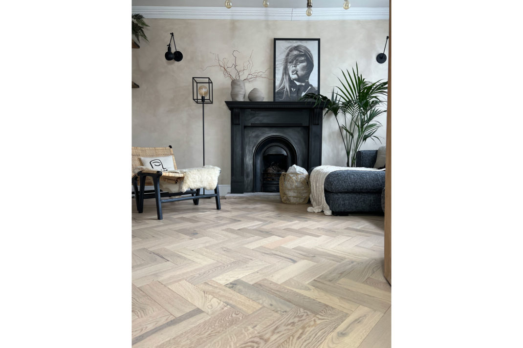 an interior with wooden flooring that's in the herringbone technique, by Luxury Flooring