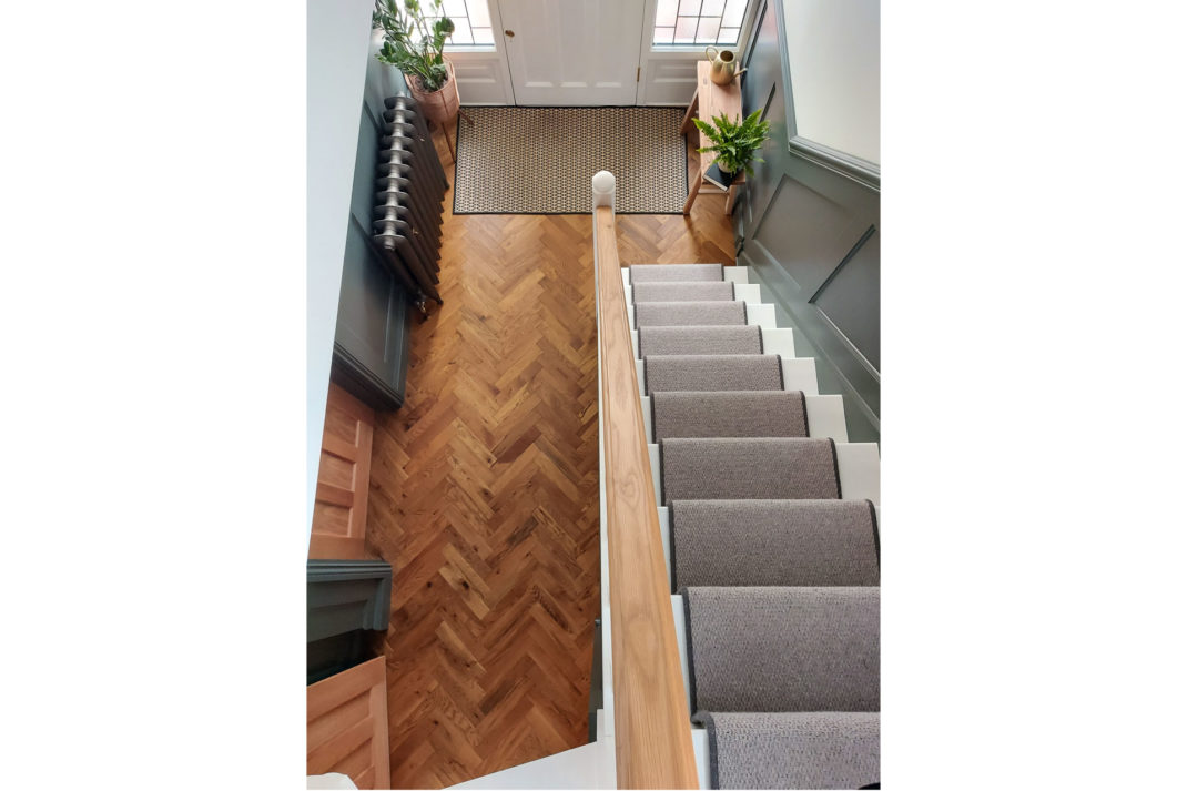 overhead view of stairs with wooden parquet flooring