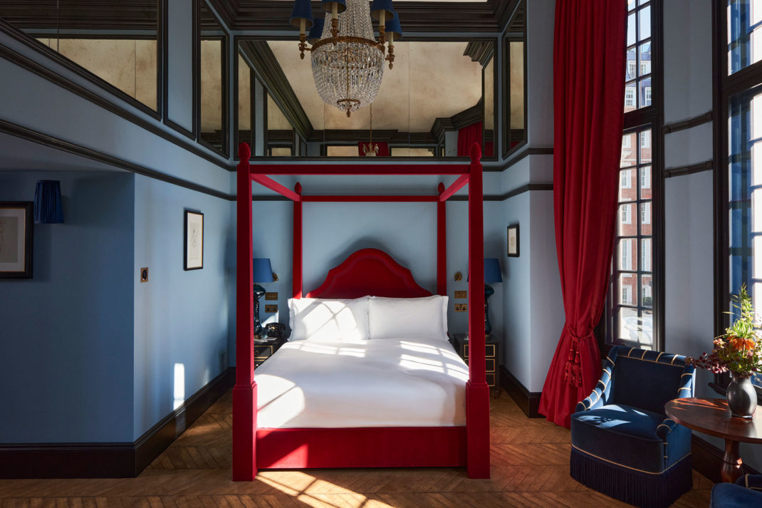 a red bed and blue walls in the new hotel in Mayfair, Twenty Two, designed by Natalia Miyar