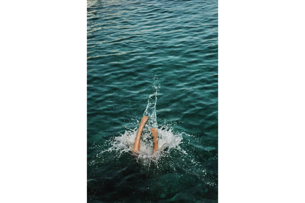 a photograph of a person diving into the sea, shot by Lucy Laucht