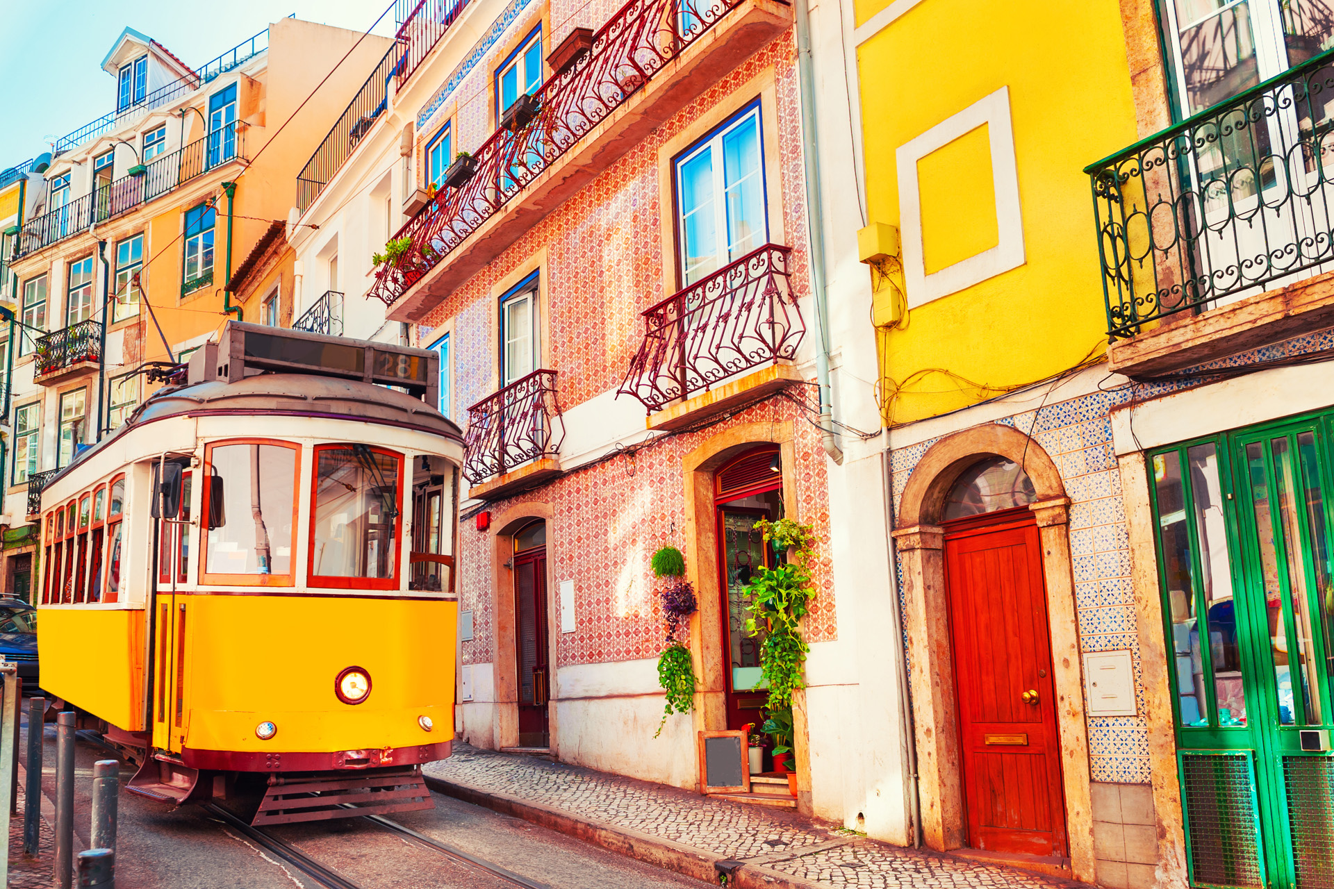 Yellow vintage tram on the street in Lisbon, Portugal.