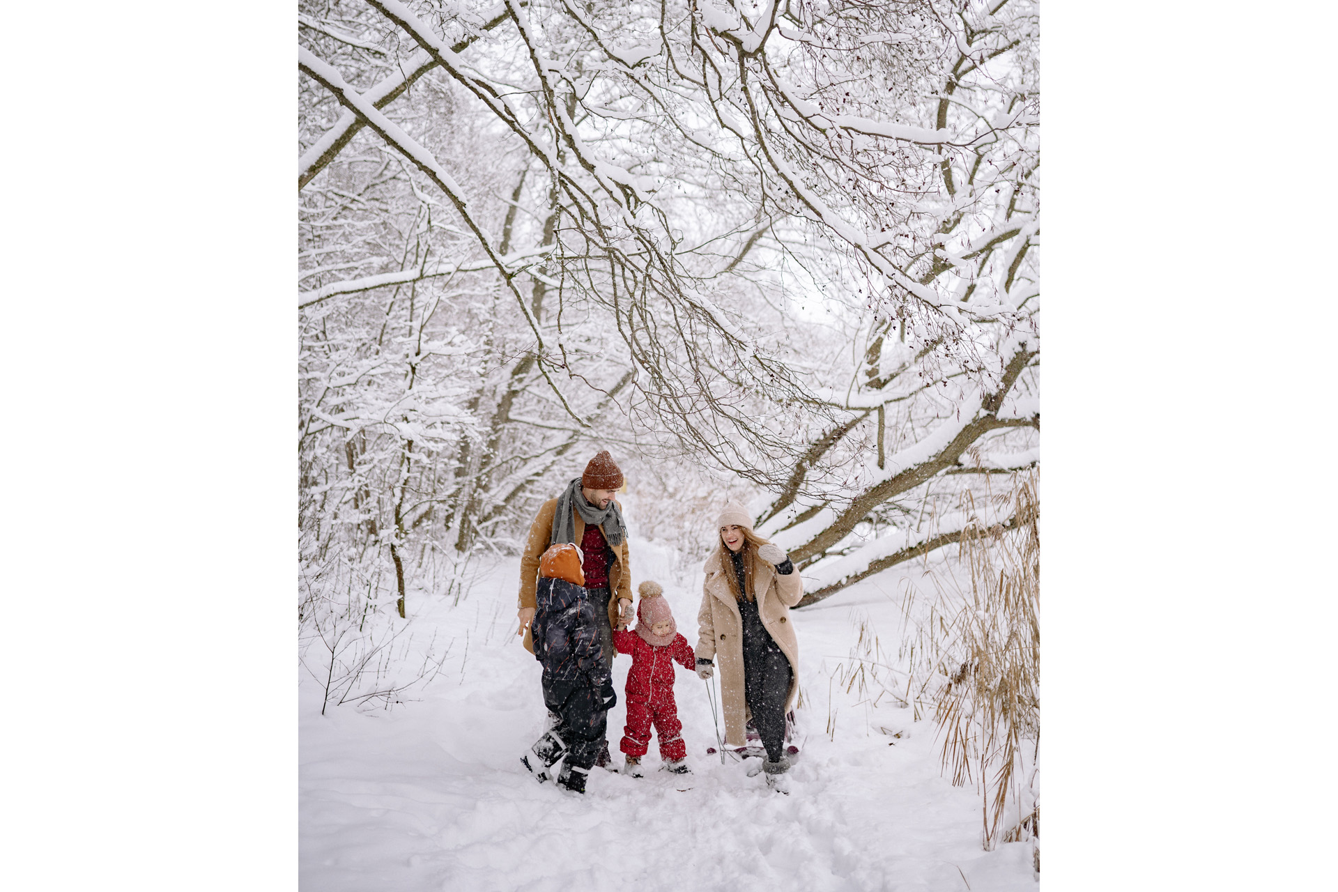 a family walking through the snow