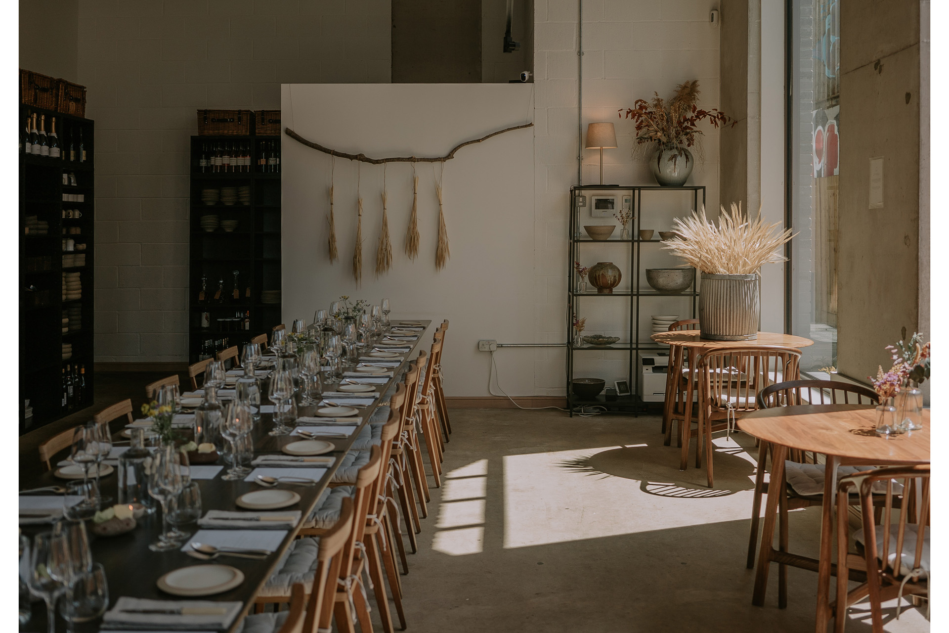 A long dining table with the light flooding in