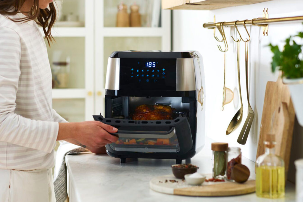 Black air fryer on marble countertop