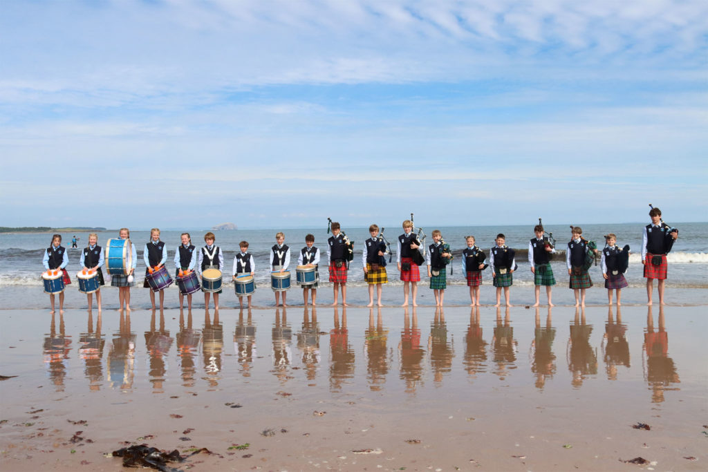 Pipe band on the beach near the school