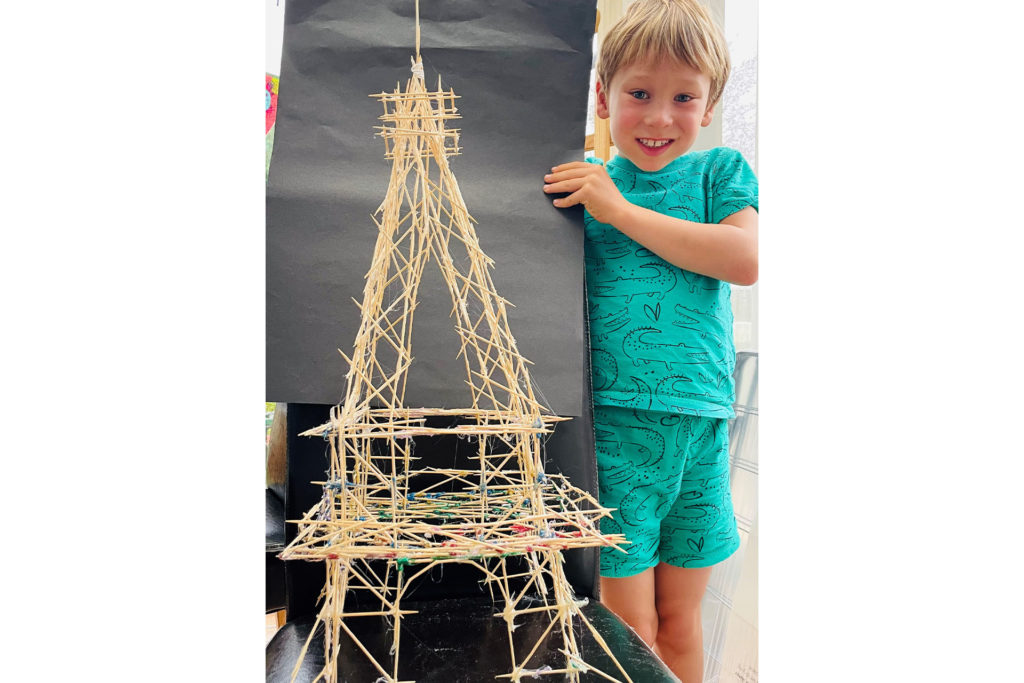 Zachary and the Eiffel Tower he built from cocktail sticks