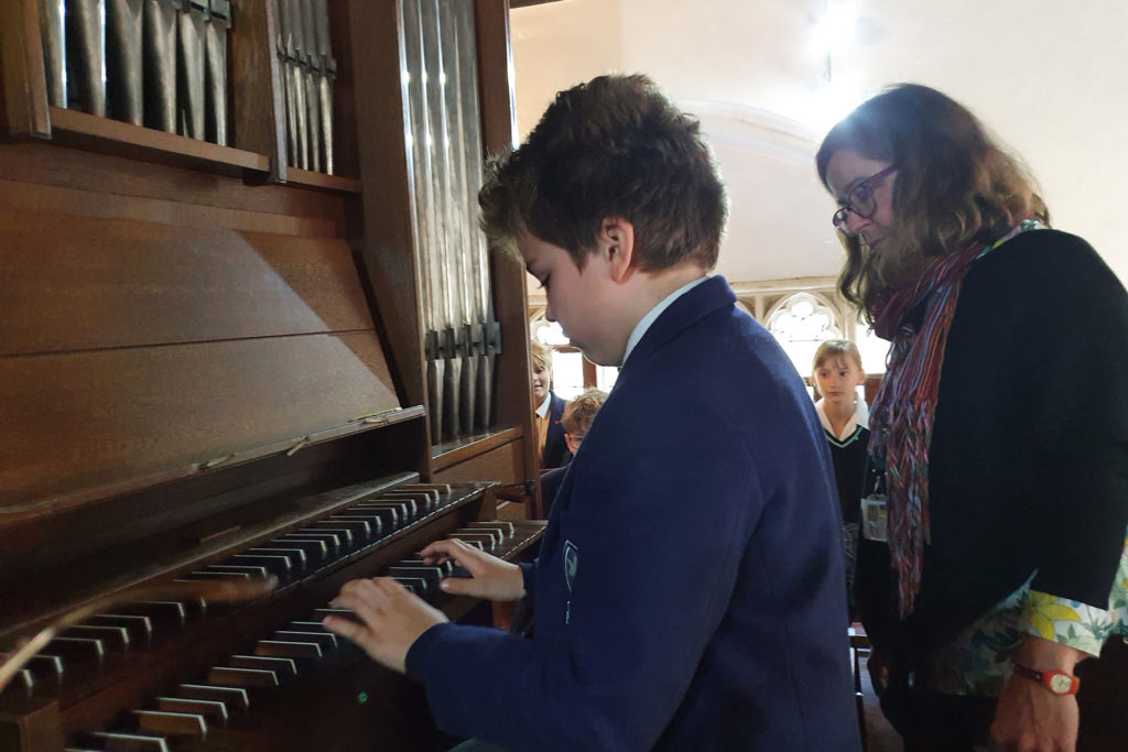 Pupil playing the organ