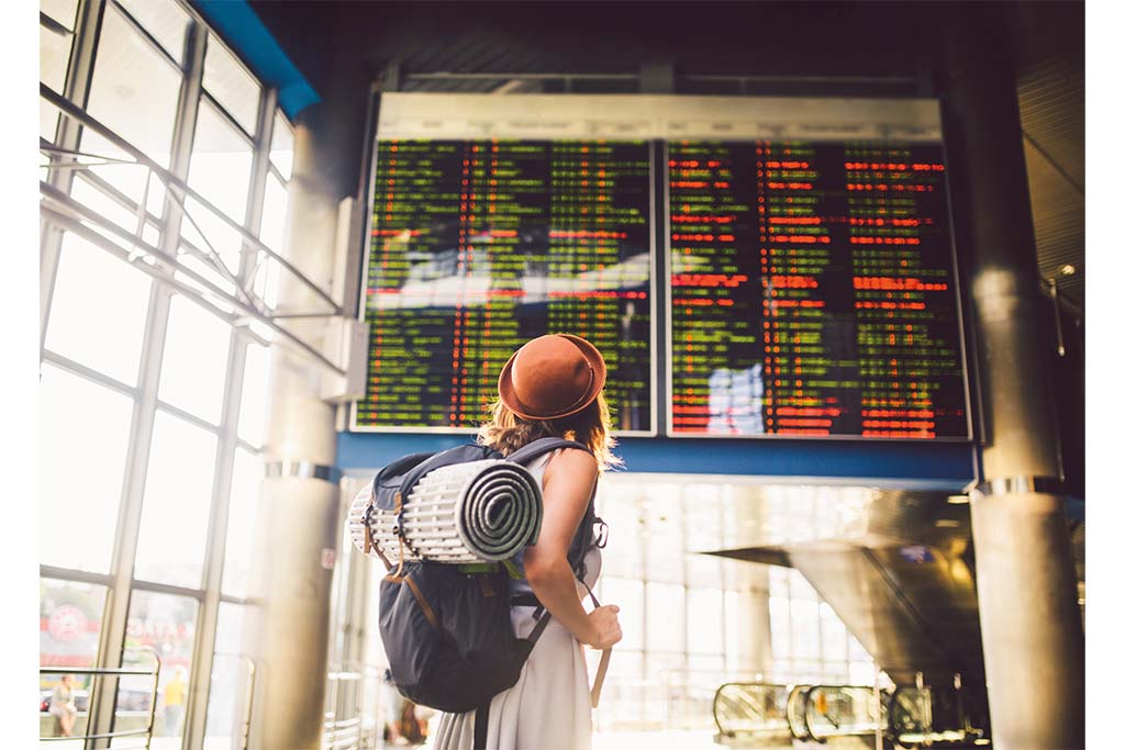 gap year advice: A lone traveller looking for her departure times @ Getty Images