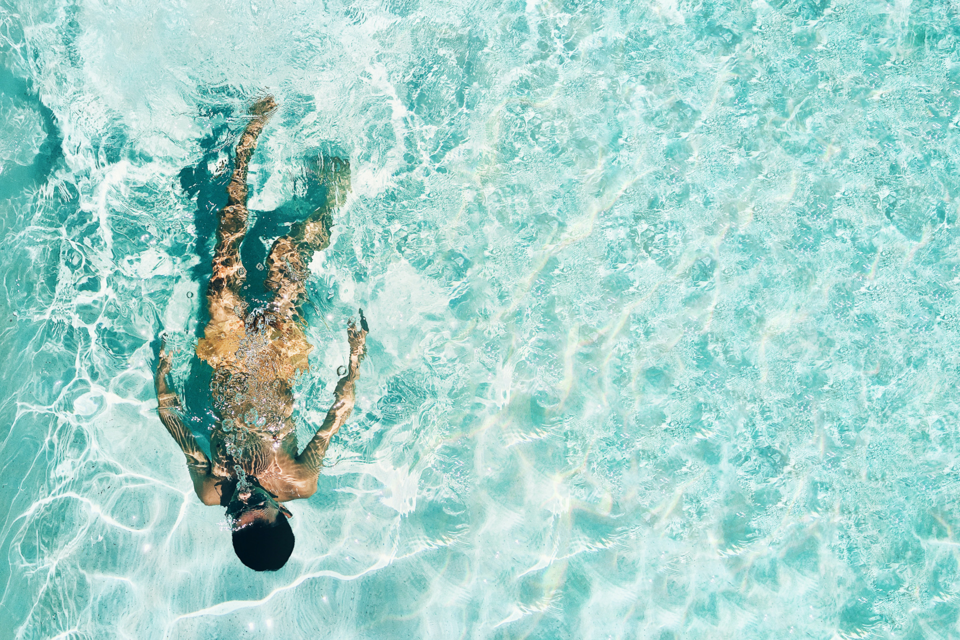 Man swimming in blue water