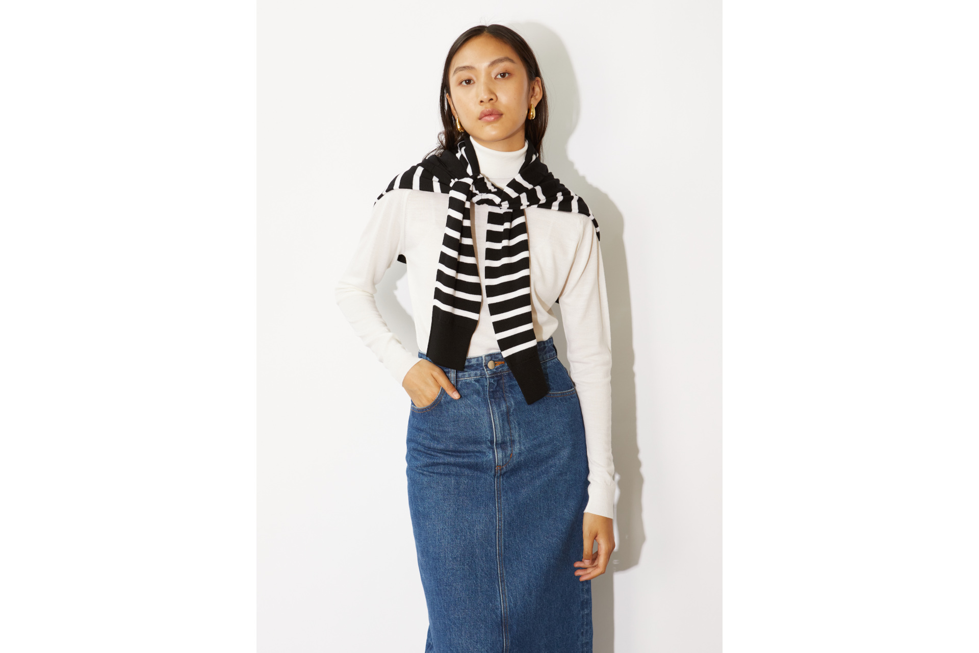 Woman in black Breton stripe jumper and white top