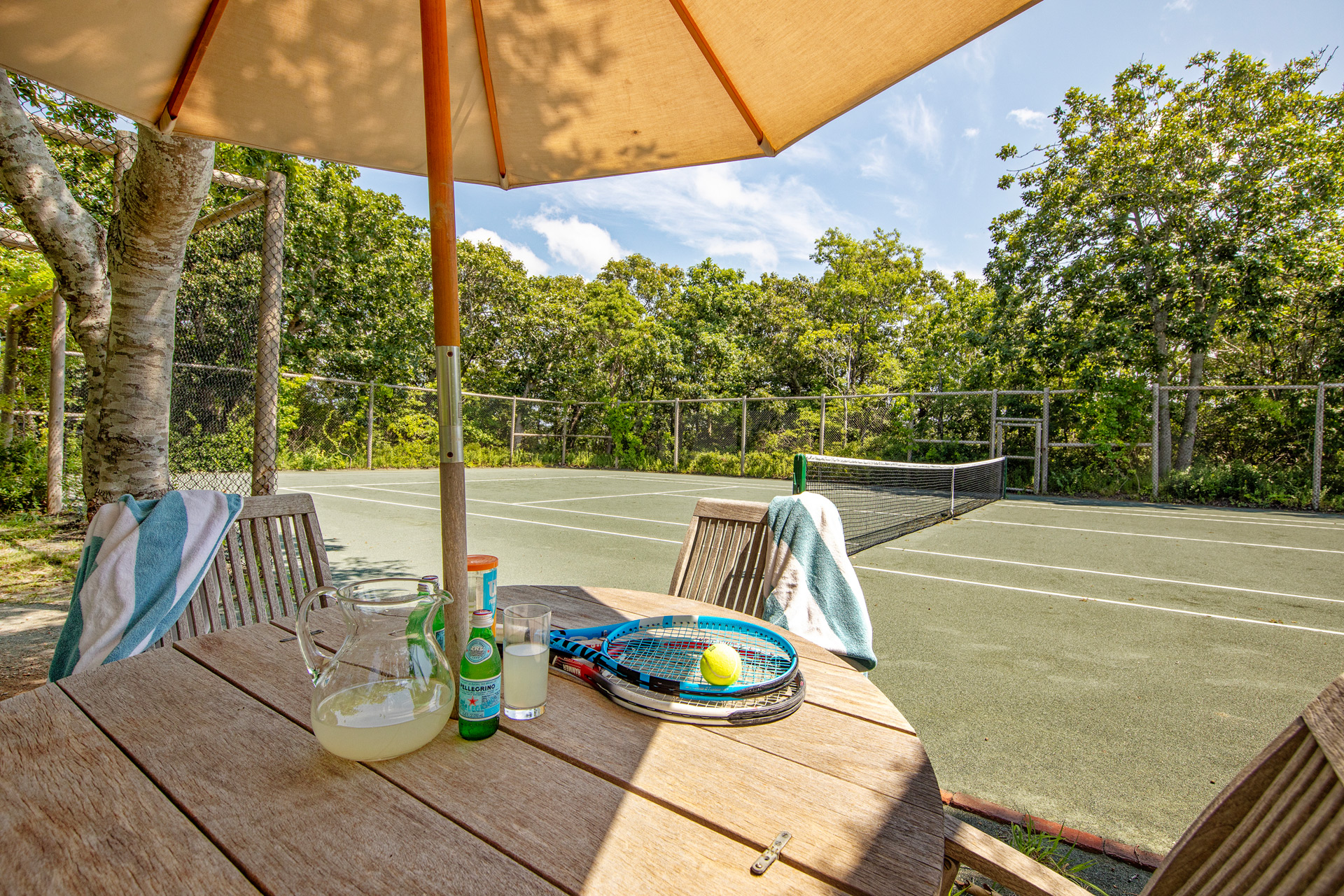 Tennis court with wooden table in the corner