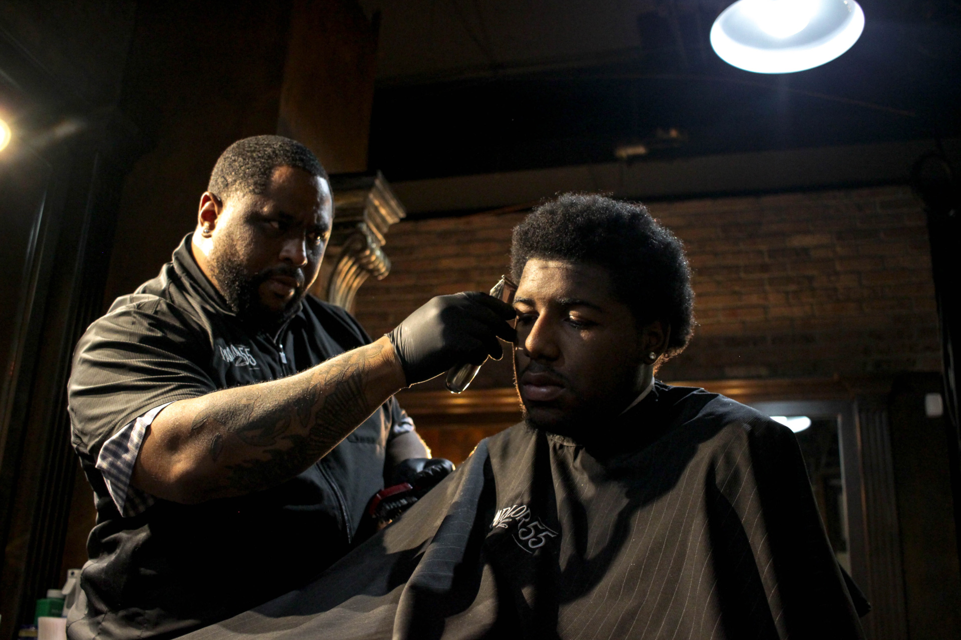 Man getting hair cut by barber