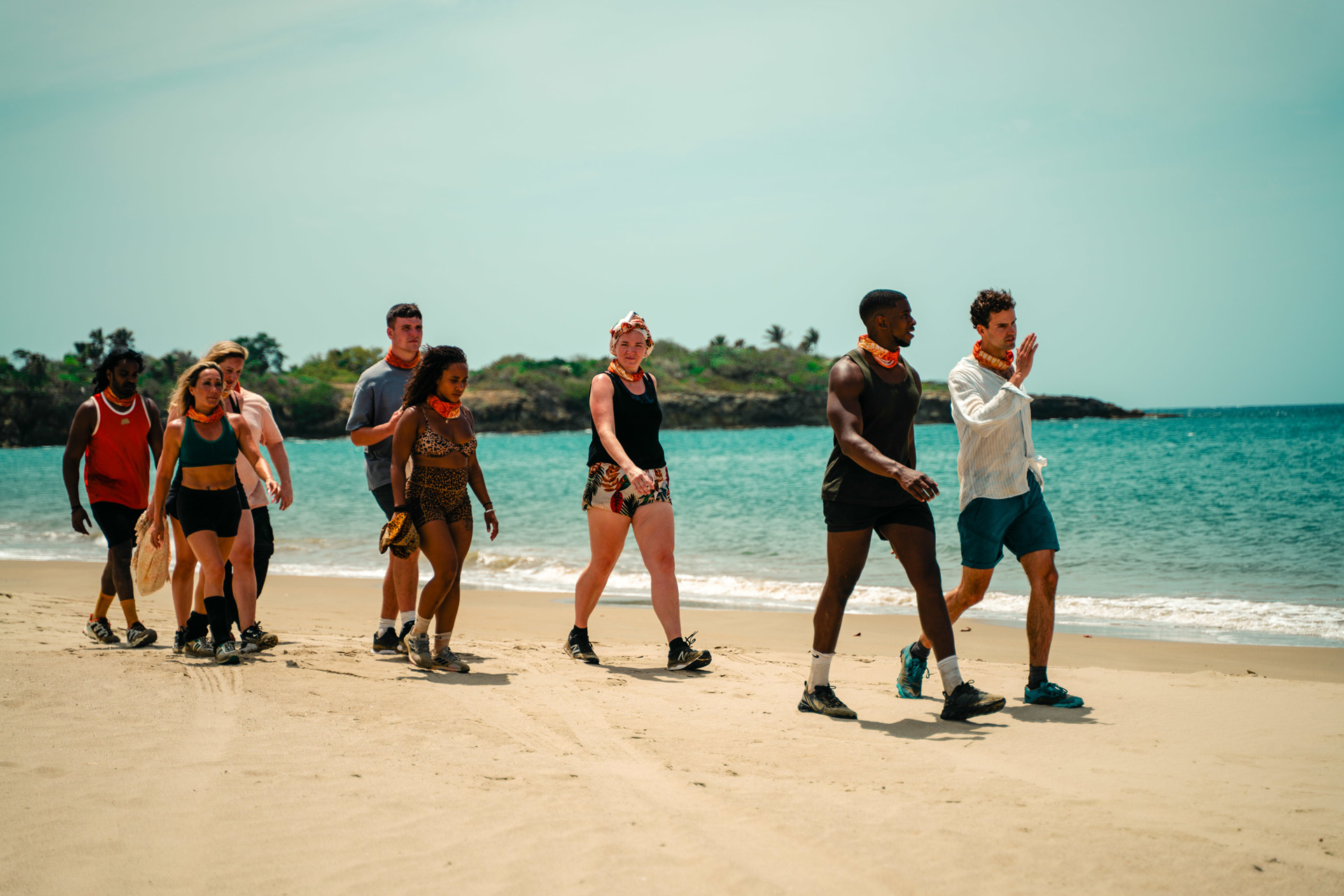 Survivor contestants walking along the beach