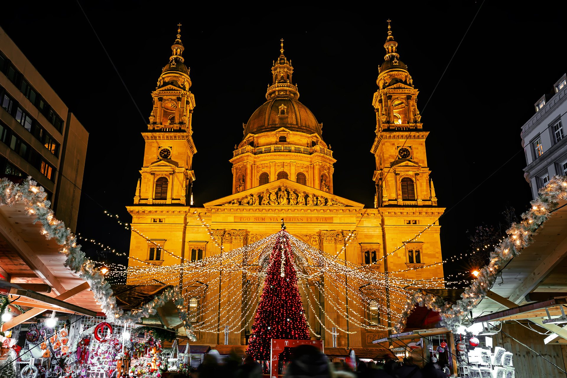 Christmas market on Vorosmarty square before Saint Stephen basilica in the evening lights - Budapest, Hungary