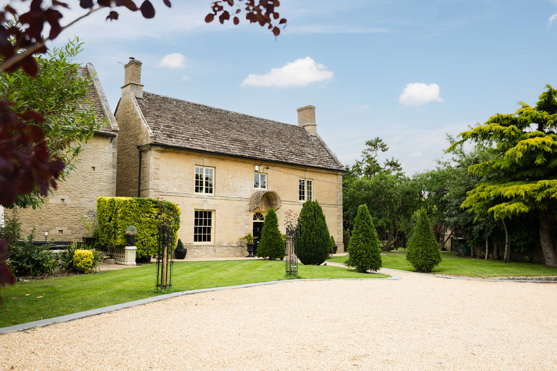 Georgian country estate with gravel driveway.