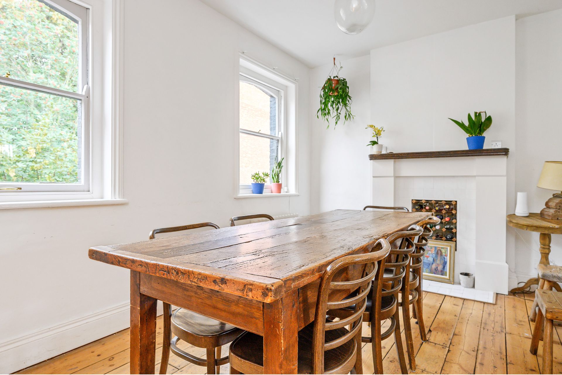 Dining room with wooden floors and fireplace