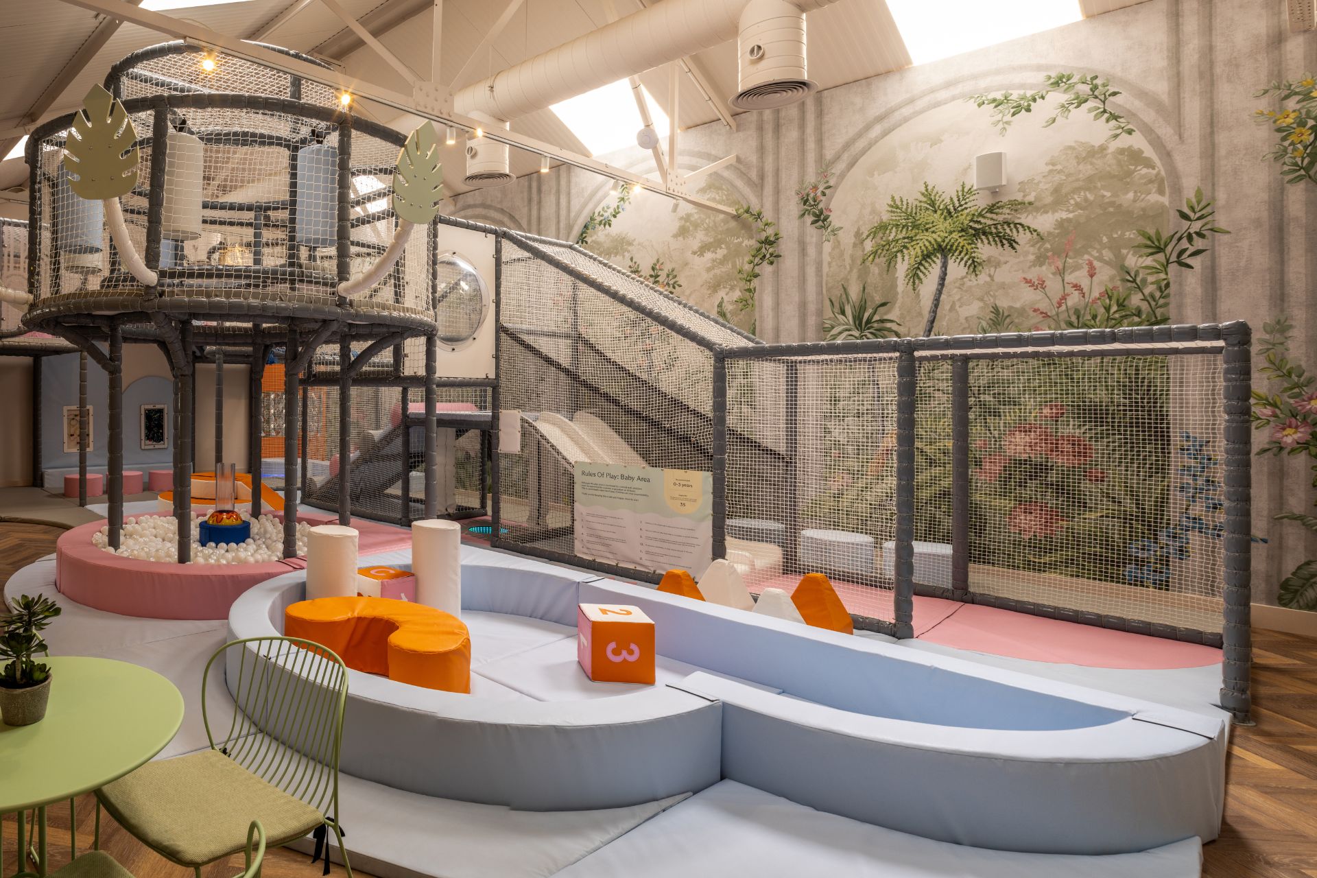 Soft play area with rainforest-themed wallpaper and pale blue accents