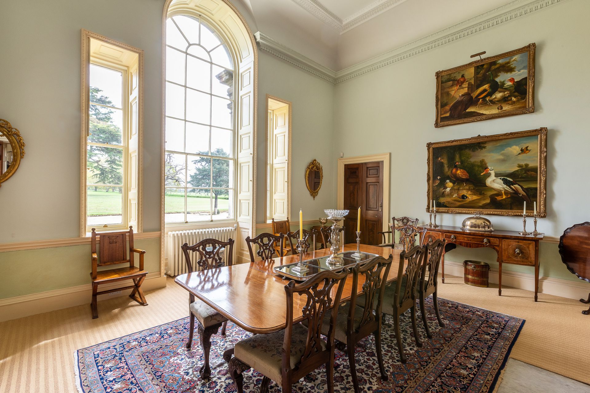 Dining room with arched windows and long mahogany table