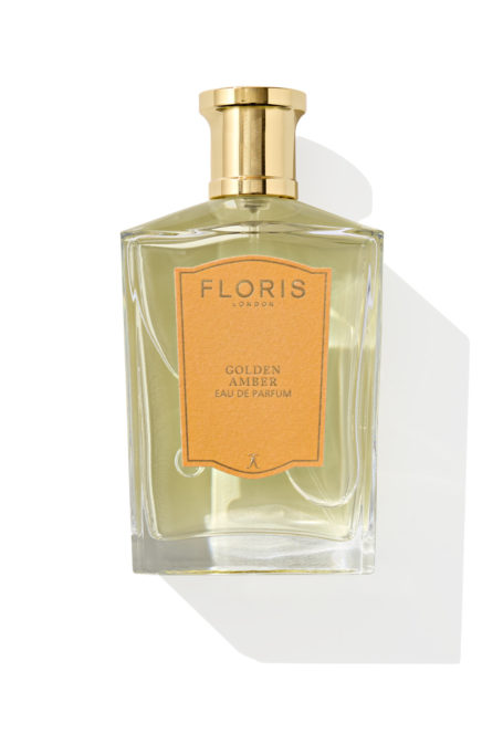 Gold perfume bottle on white background