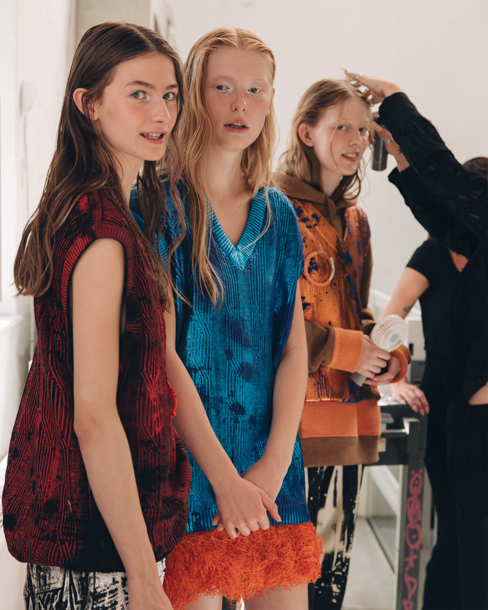 Models backstage wearing silver eyeshadow