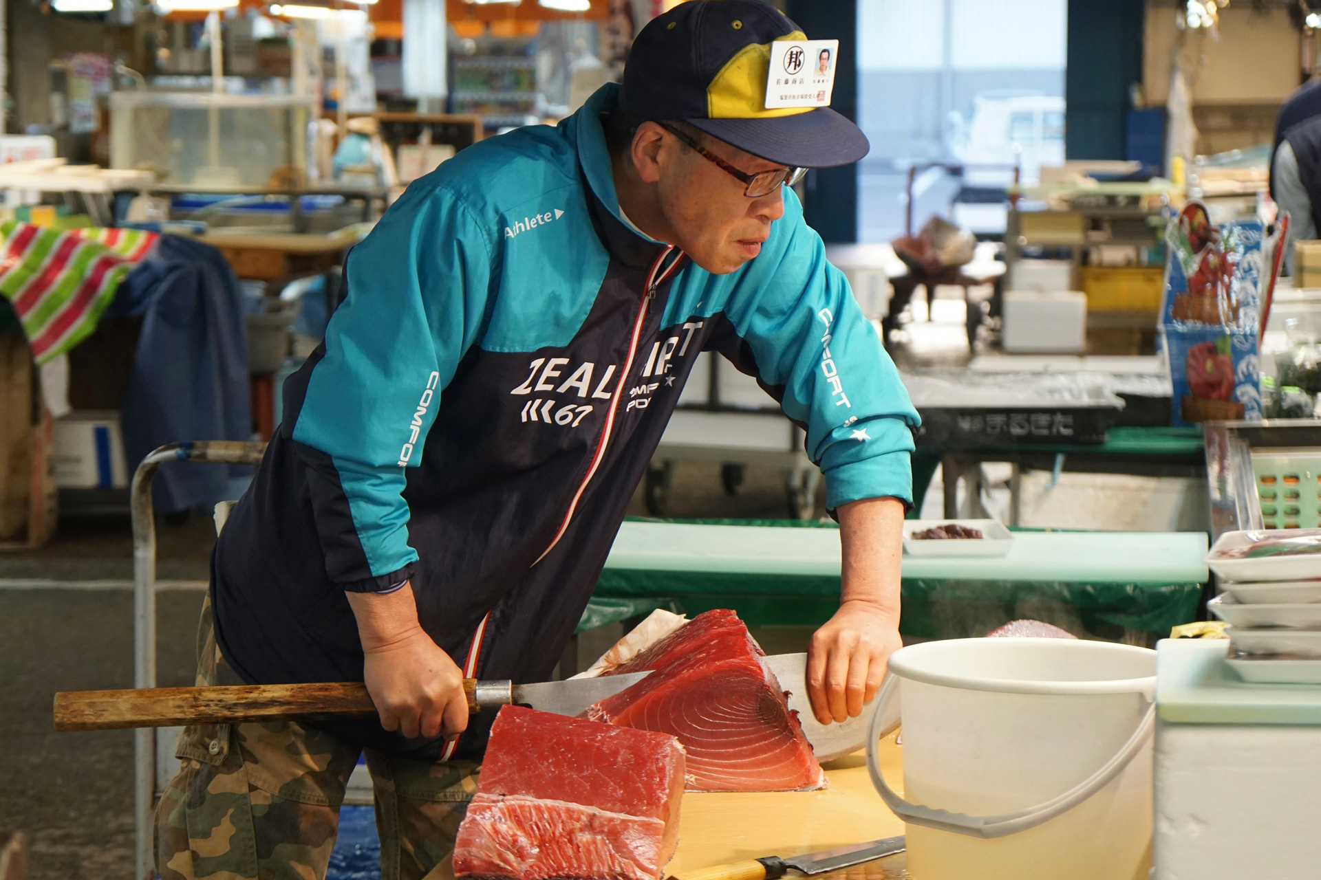 Man slicing a tuna at a fish market in Toyko