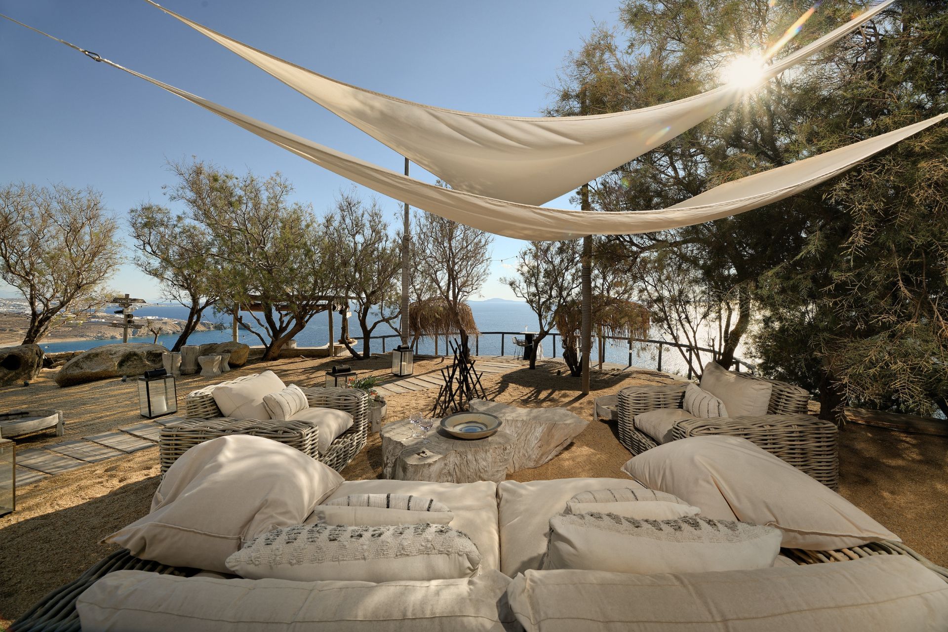 Villa terrace with white sofas and a canvas canopy