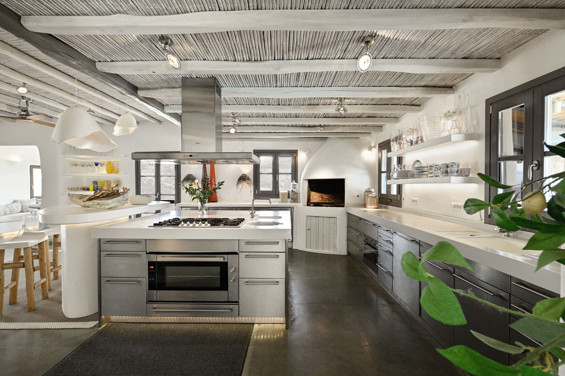 Villa kitchen with aluminium cabinets, white worktops and a large island